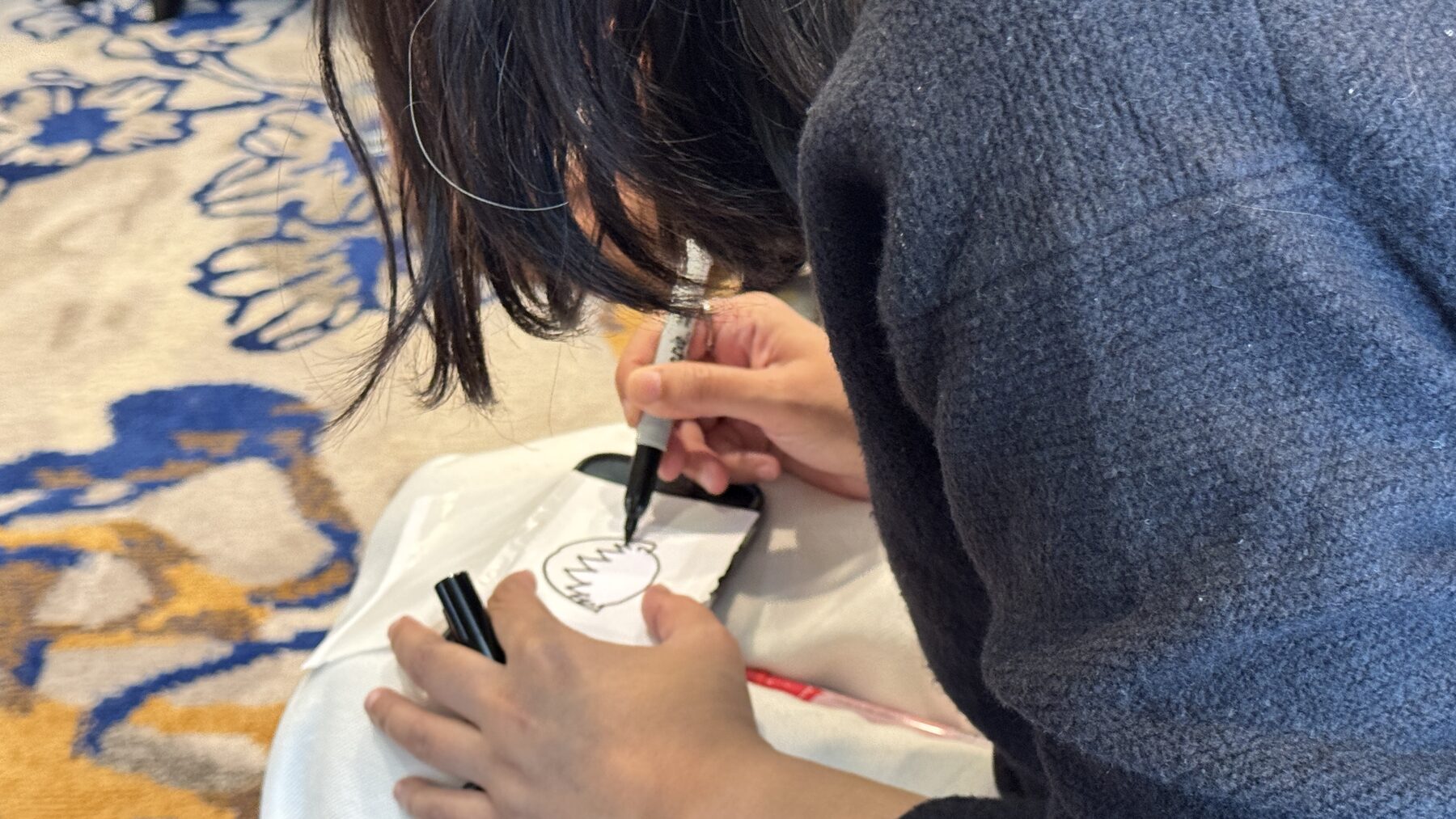 Hands sketching ideas on paper during an Empathic Agility session